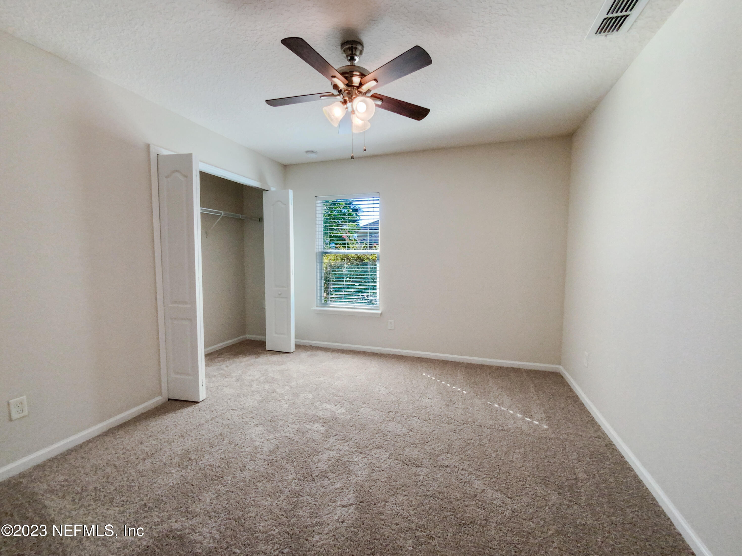 56 Irish Rose Road St. Augustine, FL 32092 - Photo 16 of 25 an empty room with ceiling fan and window
