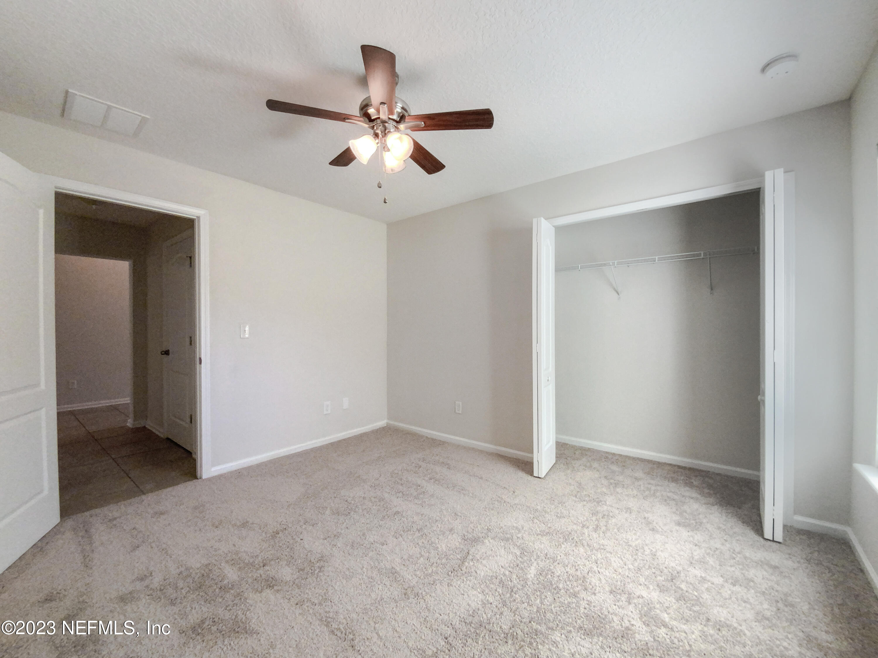 56 Irish Rose Road St. Augustine, FL 32092 - Photo 17 of 25 a view of an empty room with a fan