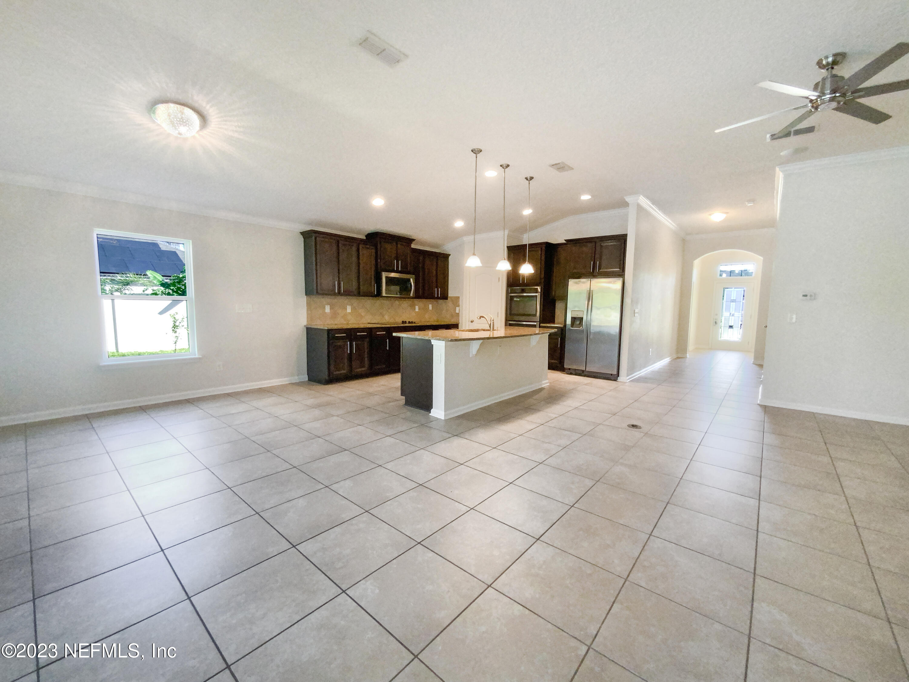 56 Irish Rose Road St. Augustine, FL 32092 - Photo 6 of 25 a large kitchen with kitchen island a sink stainless steel appliances and a counter top space