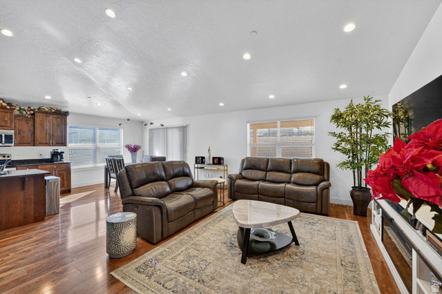 141 Wolverine Creek Elk Ridge, UT 84651 - Photo 6 of 47 Living room with dark wood-style floors, a textured ceiling, and recessed lighting