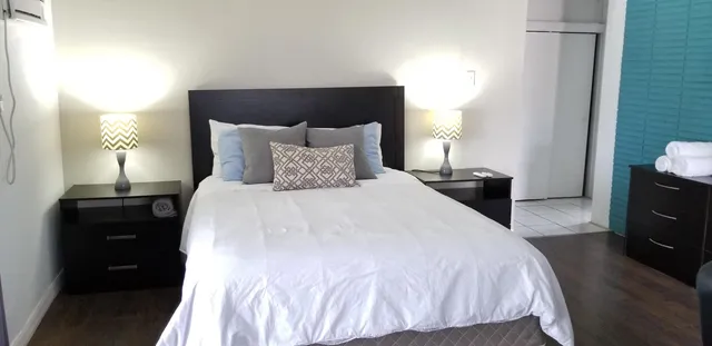 a bedroom with a bed and a tv on the dresser