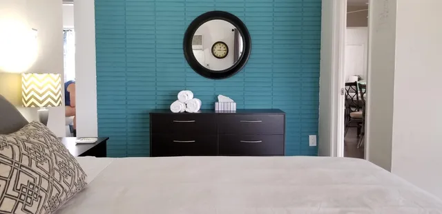 a bedroom with a bed and a dresser