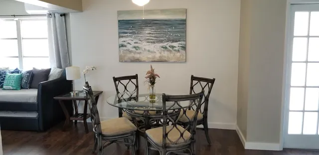 a view of a dining room with furniture window and wooden floor