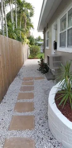 a view of backyard with outdoor seating and plants