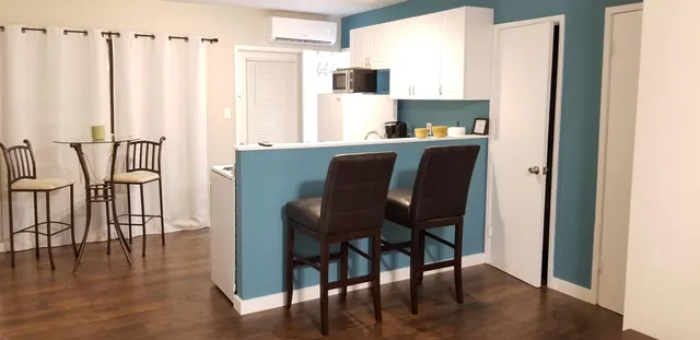 a view of kitchen with furniture and wooden floor