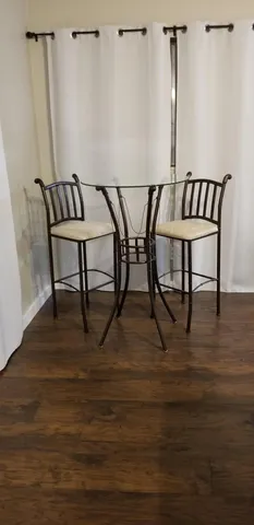 a view of a room with furniture and wooden floor