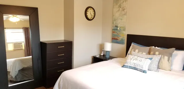 a bedroom with a bed and a window