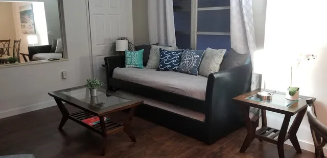 a living room with furniture and a potted plant