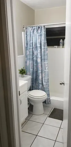 a bathroom with a toilet a sink and a shower