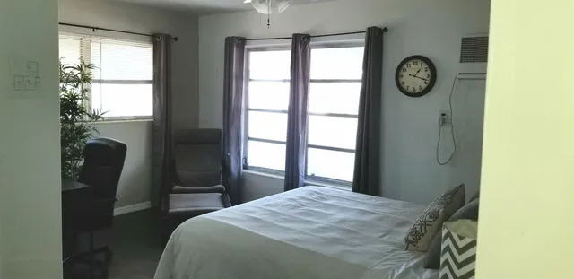a bedroom with a bed and a window