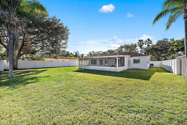 a view of a house with a backyard