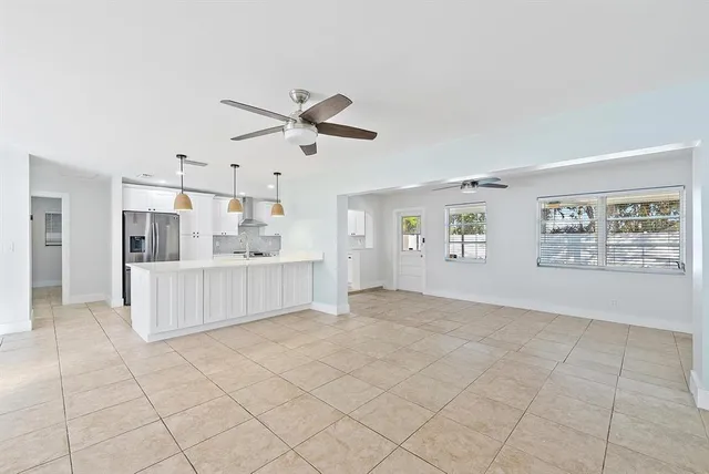 a view of a kitchen with furniture and natural light