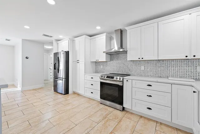 a kitchen with stainless steel appliances a refrigerator sink and cabinets