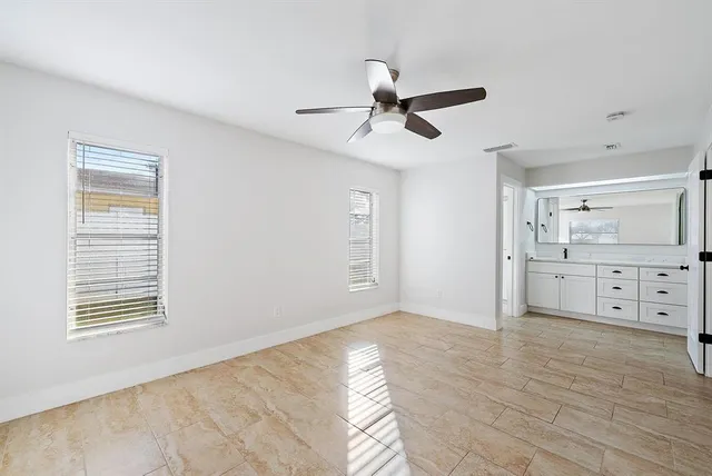 a view of a big room with windows and cabinet