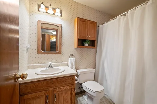a bathroom with a sink toilet and shower