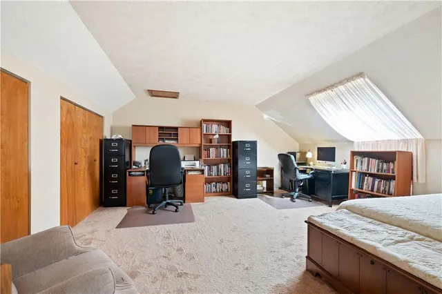 a bedroom with furniture and a large window