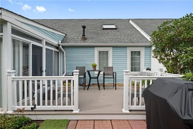 a view of house with a deck and furniture