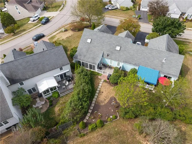 an aerial view of a house with a yard