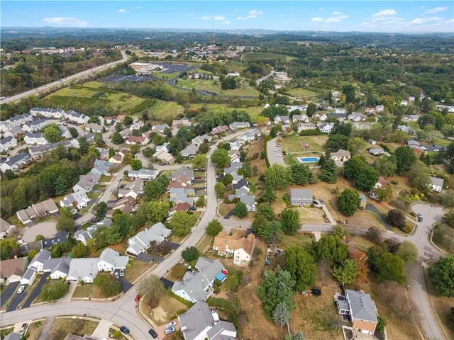 an aerial view of residential building with parking