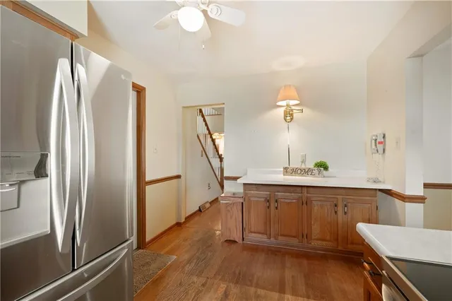 a kitchen with kitchen island a counter top space wooden floor and appliances