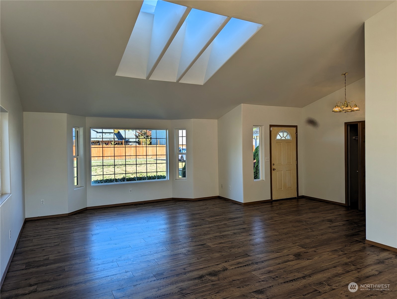 7132 183rd Avenue Southwest Rochester, WA 98579 - Photo 8 of 40 an empty room with wooden floor and windows