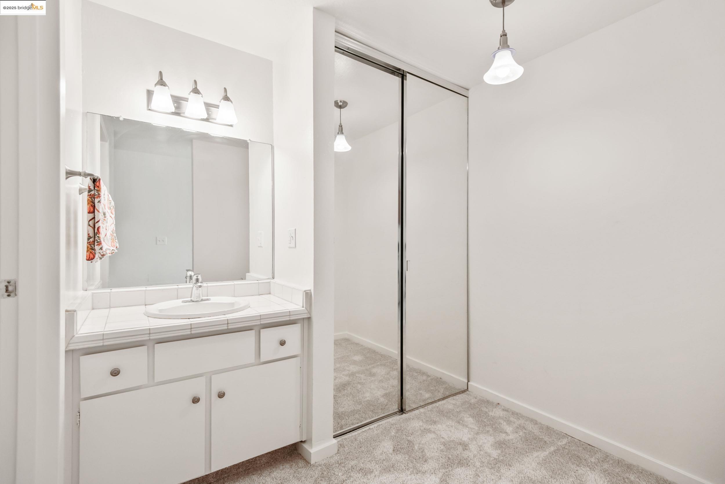 288 Whitmore Street, Unit 310B Oakland, CA 94611 - Photo 20 of 37 a bathroom with a sink vanity and a mirror