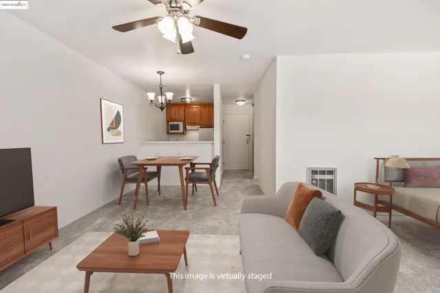 a living room with furniture a rug and a flat screen tv