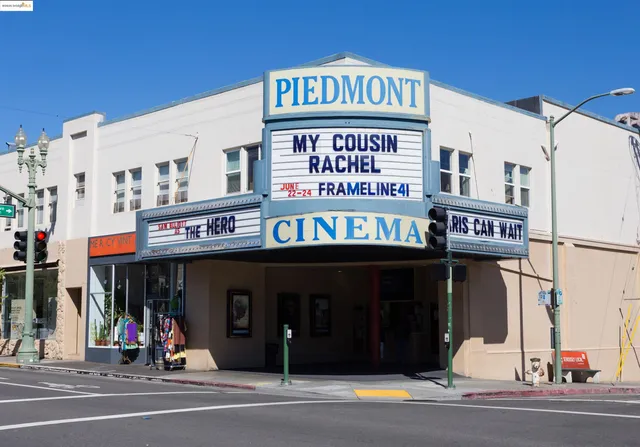 a group of people sitting in front of retail shops