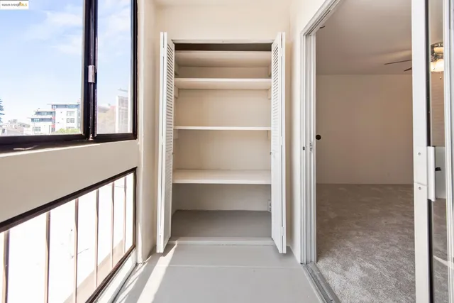 a view of walk in closet with empty racks
