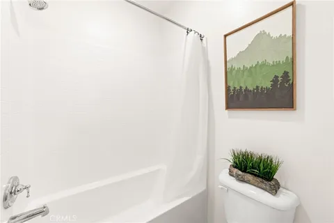 a bedroom with a bed and a potted plant