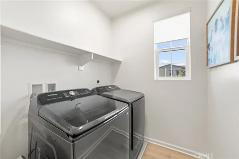 a spacious bedroom with a bed and a chandelier