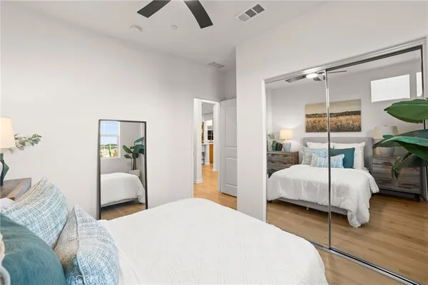a bedroom with a bed and wooden floor