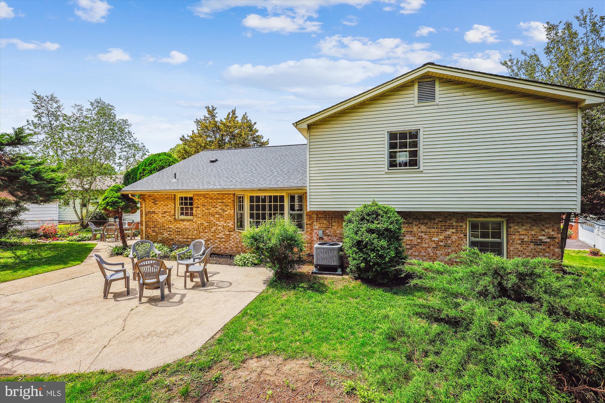 1029 Tracy Drive Silver Spring, MD 20904 - Photo 52 of 59 a white house with a table and chairs under an umbrella