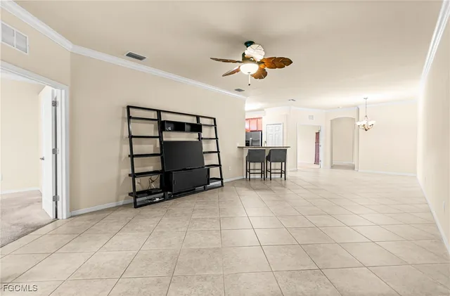 a view of a dining room with furniture and a chandelier fan