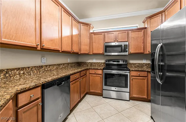 a kitchen with granite countertop a stove and a microwave