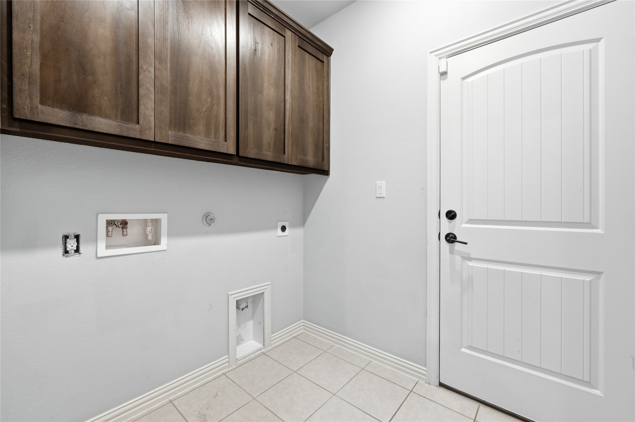 426 Cold Riv Run Kyle, TX 78640 - Photo 27 of 34 Functional utility room with ample storage cabinetry and tiled flooring, ready for your appliances.