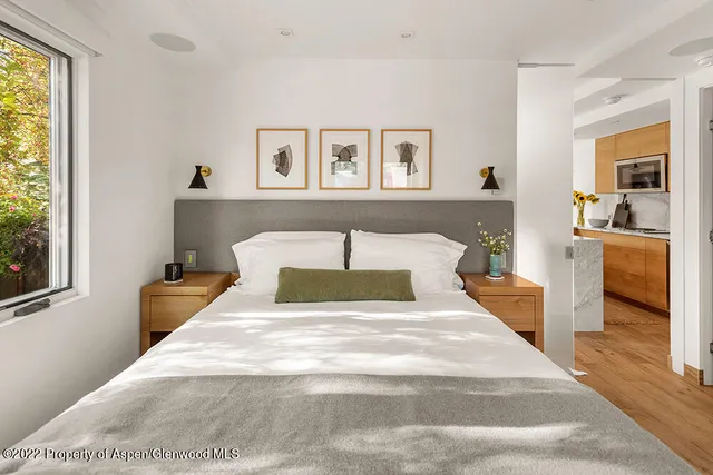 a bedroom with a bed and a large mirror