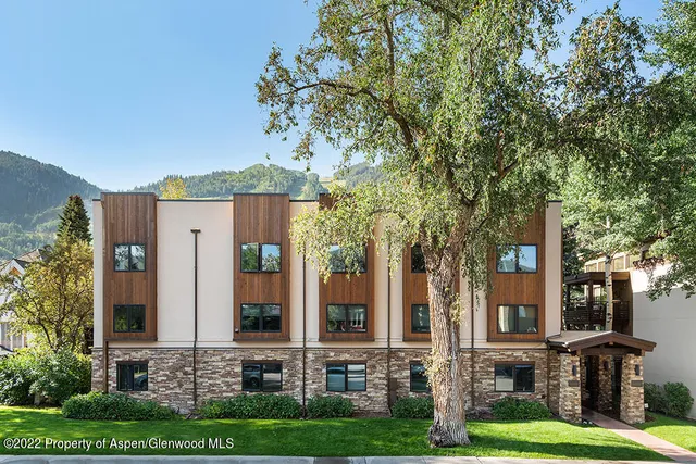 front view of a brick house with a yard