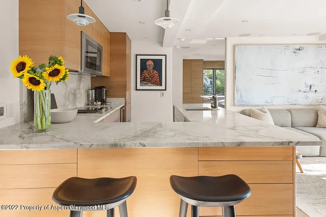 a bathroom with a granite countertop sink a mirror and vanity