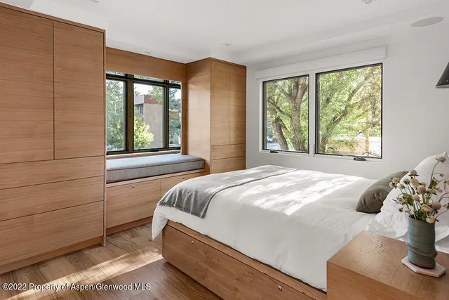 a bed sitting in a bedroom next to a window