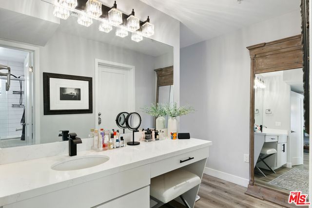 a bathroom with a sink a large mirror and vanity