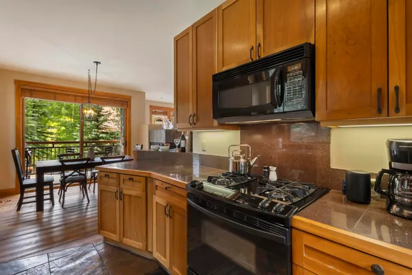 a kitchen with a stove a sink and a microwave