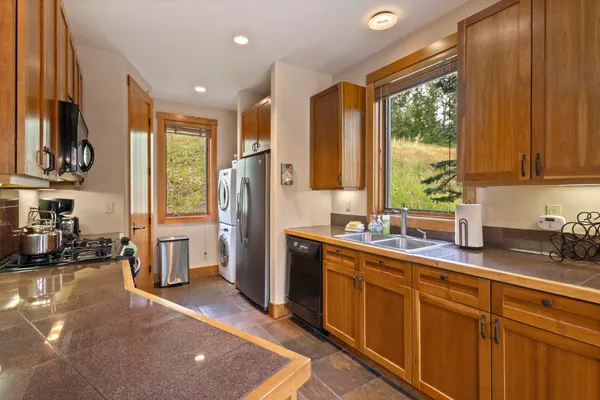 a kitchen with stainless steel appliances a sink stove and refrigerator