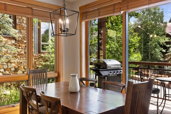 a dining room with furniture wooden floor and a potted plant