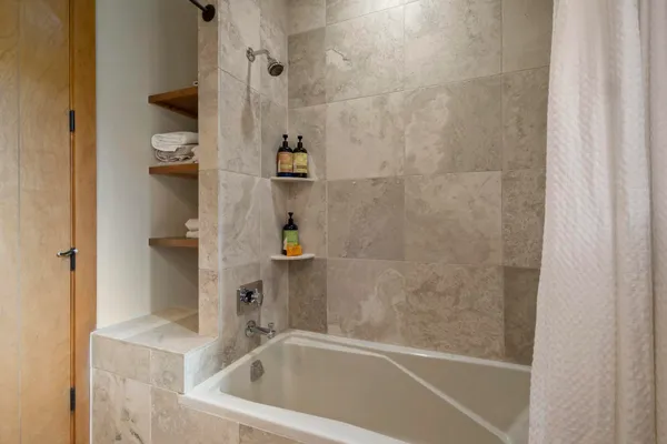 a bath tub sitting next to a bathroom