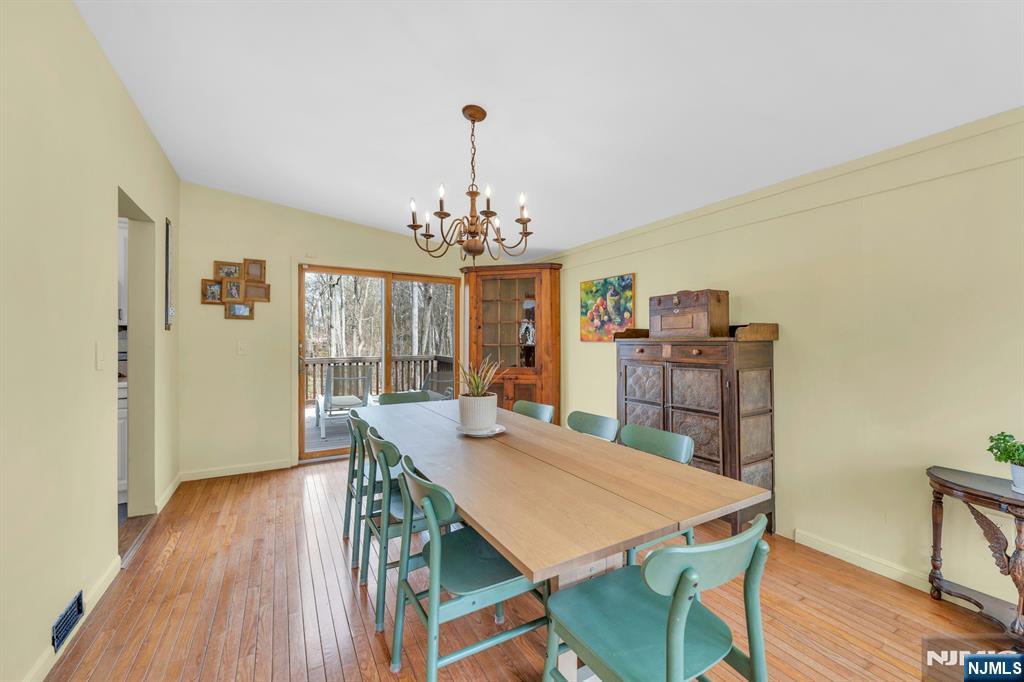 27 Bear Mountain Road Ringwood, NJ 07456 - Photo 20 of 47 a view of a dining room with furniture a chandelier and wooden floor