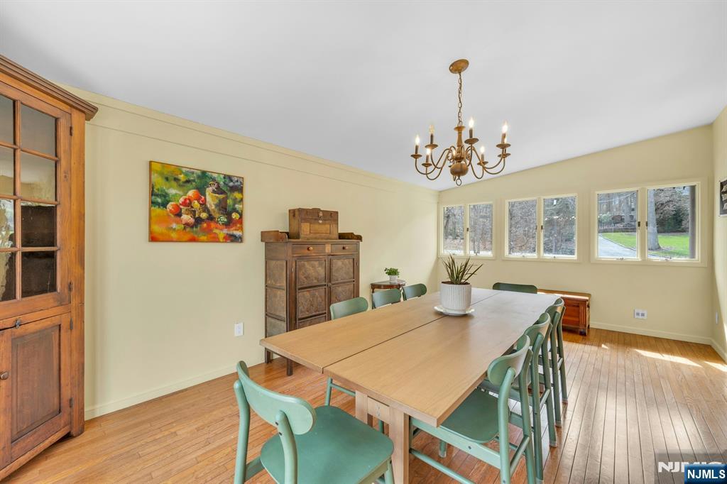 27 Bear Mountain Road Ringwood, NJ 07456 - Photo 21 of 47 a view of a dining room with furniture a chandelier and wooden floor