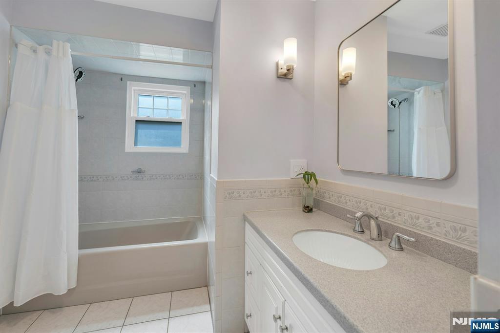 27 Bear Mountain Road Ringwood, NJ 07456 - Photo 31 of 47 a bathroom with a tub sink and mirror