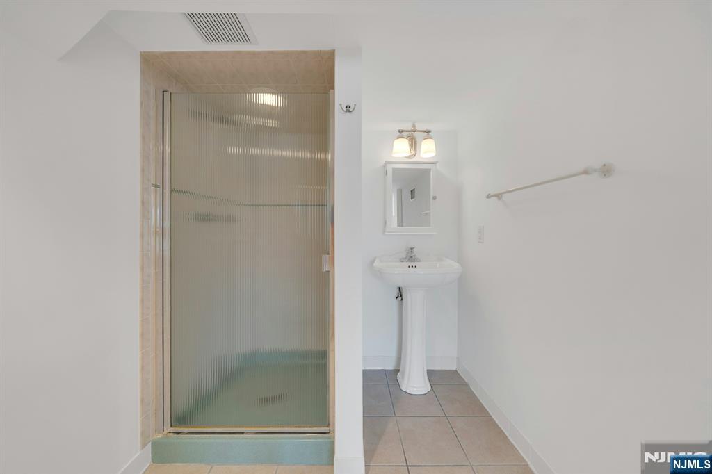 27 Bear Mountain Road Ringwood, NJ 07456 - Photo 36 of 47 a bathroom with a glass shower door