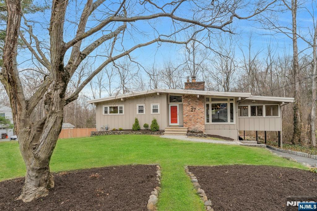 27 Bear Mountain Road Ringwood, NJ 07456 - Photo 4 of 47 a front view of a house with a yard and trees